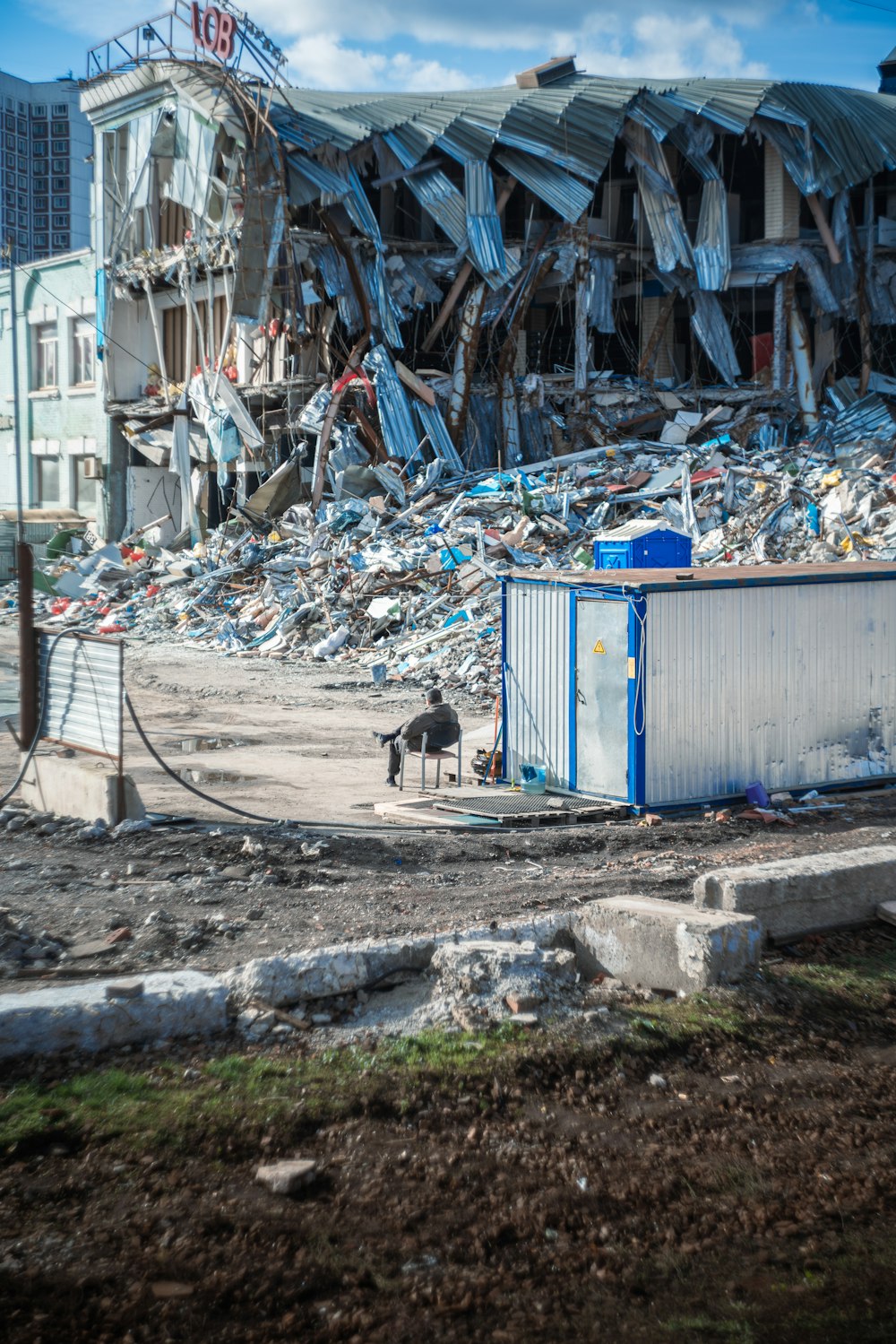 a dog standing in front of a pile of garbage