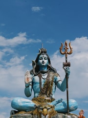 a statue of a person holding a staff and a shield