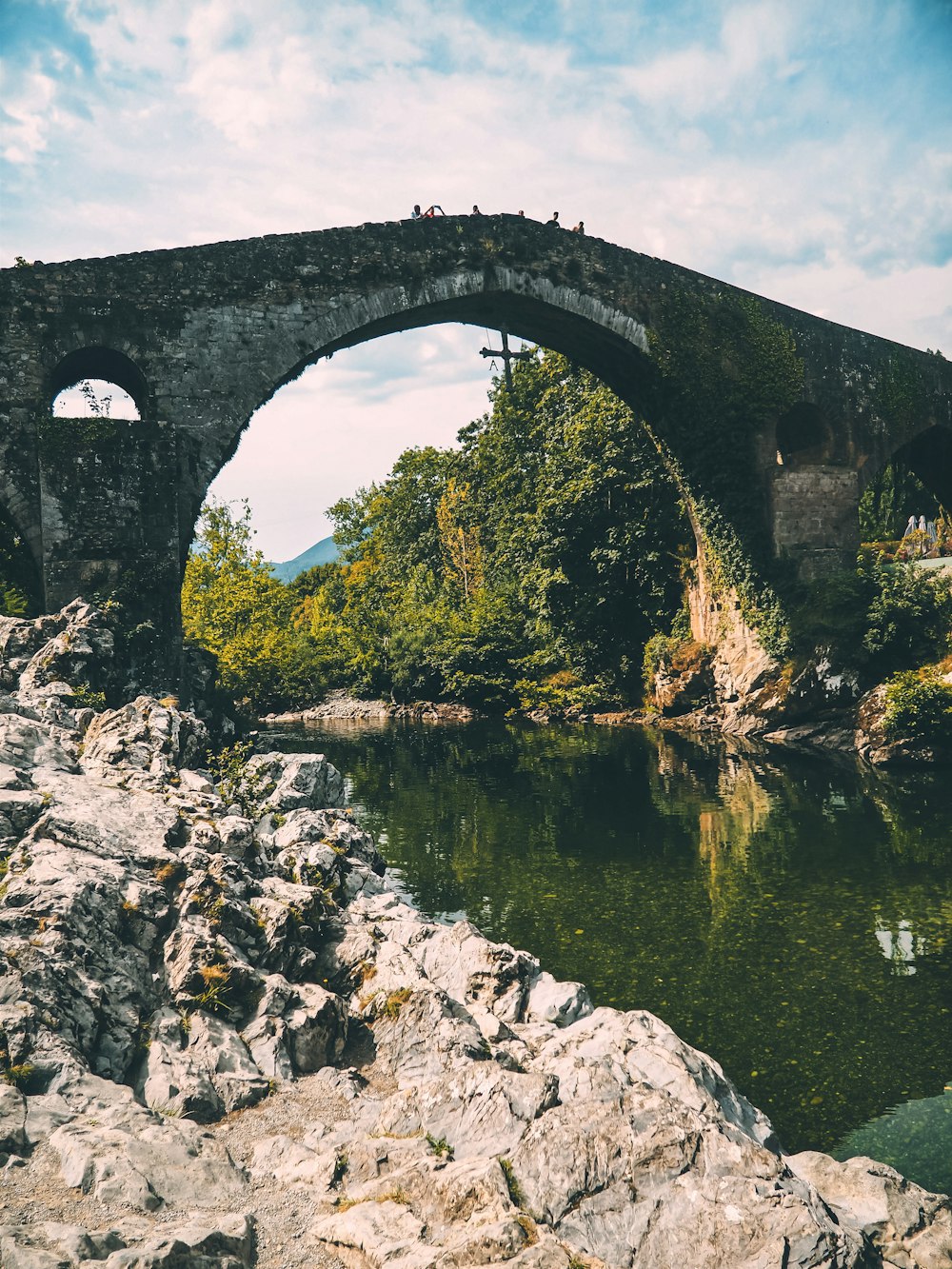 a stone bridge over a river