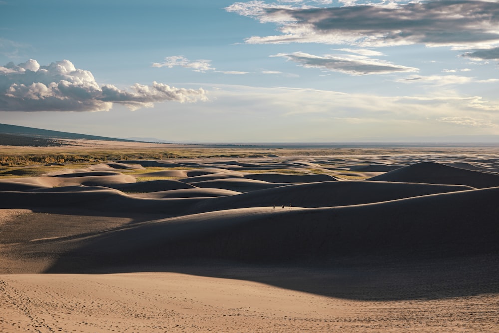 a large flat area with sand and a blue sky