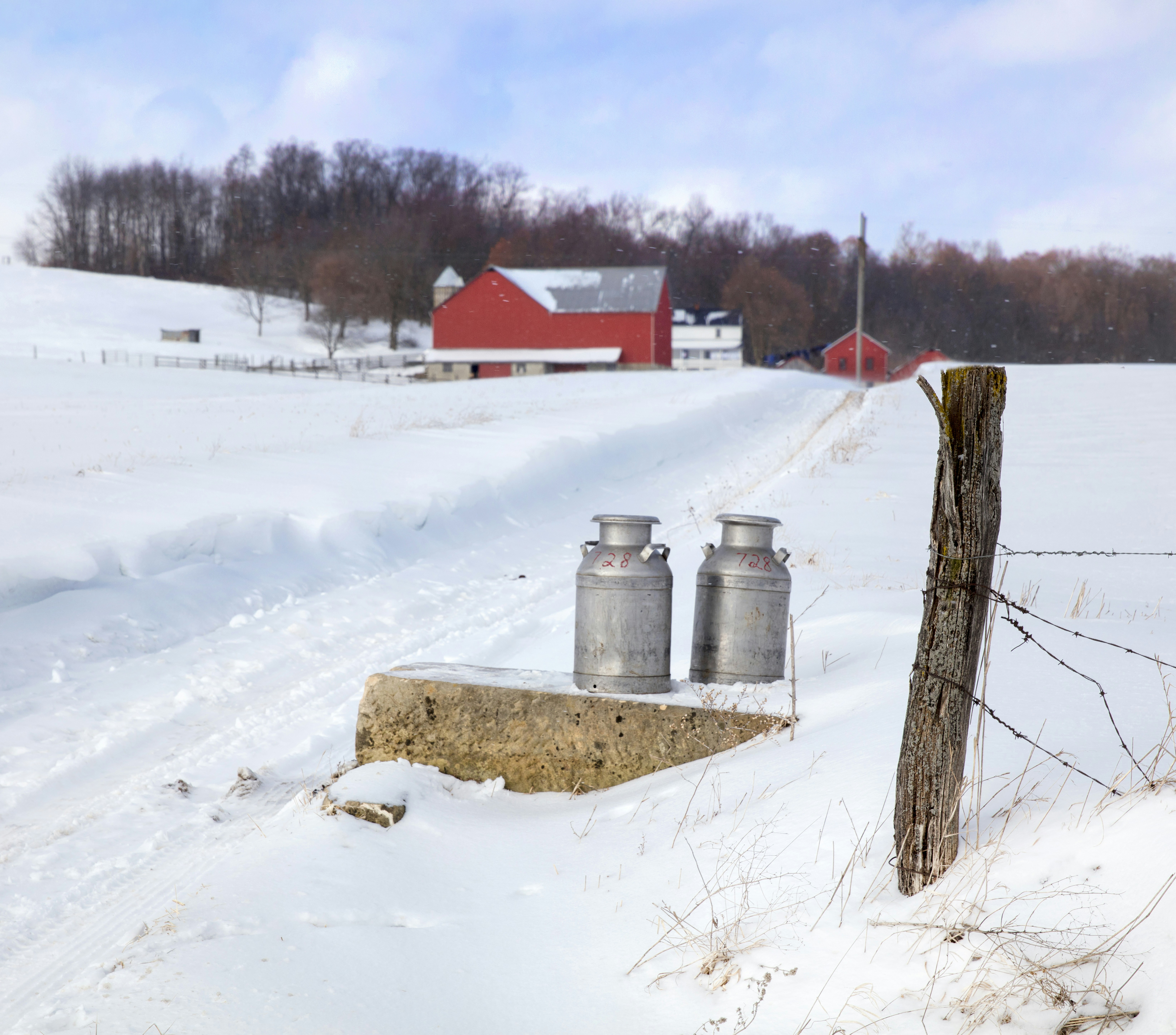 a group of metal containers in a snowy field