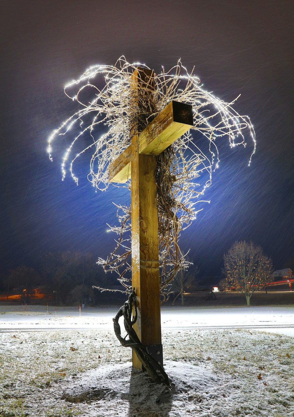 a fire hydrant on a snowy field with a star in the sky