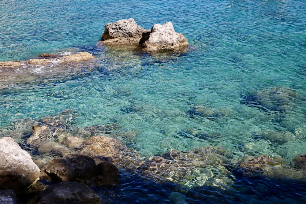 a group of rocks in the water