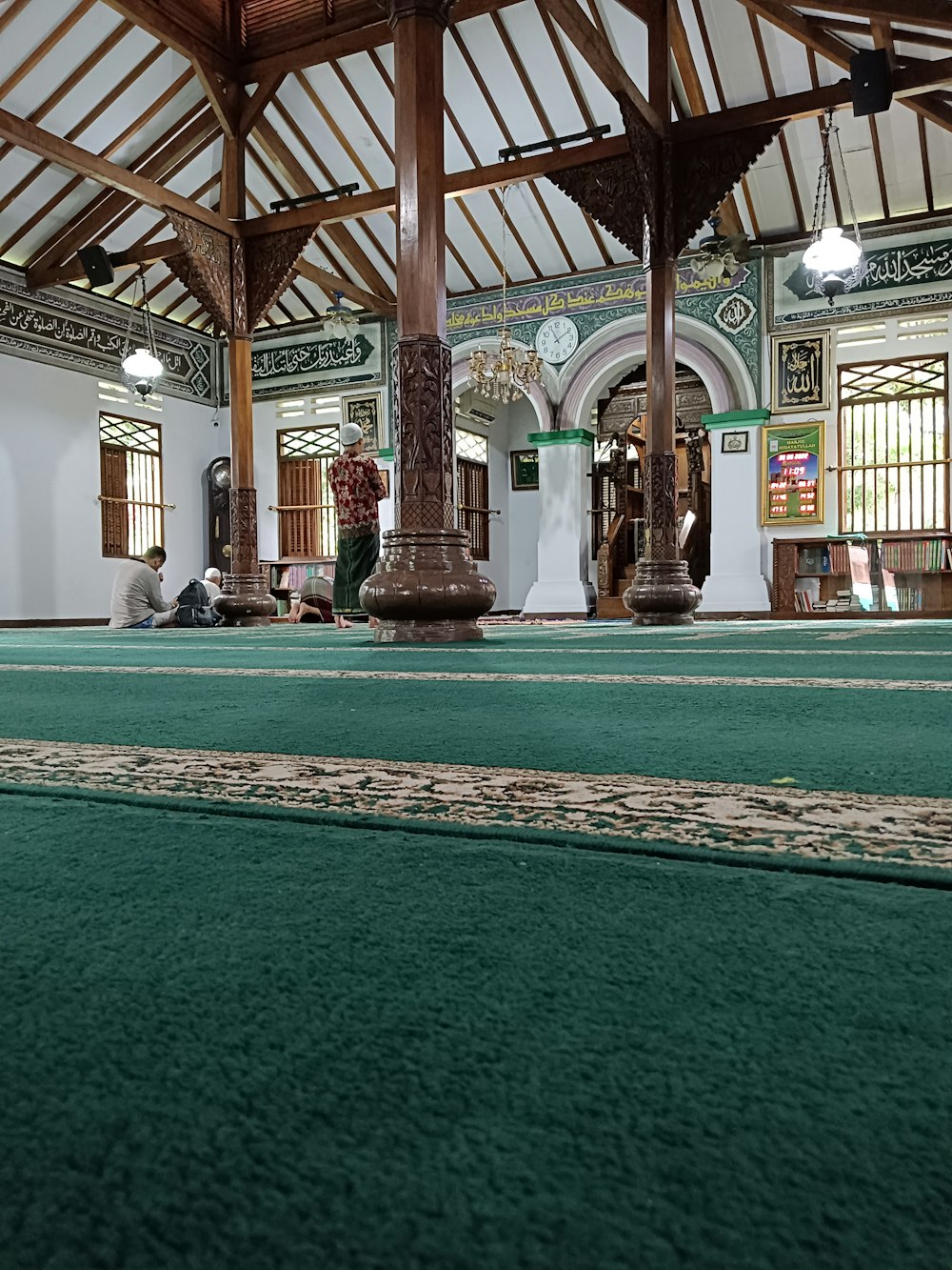 a large room with a green carpet