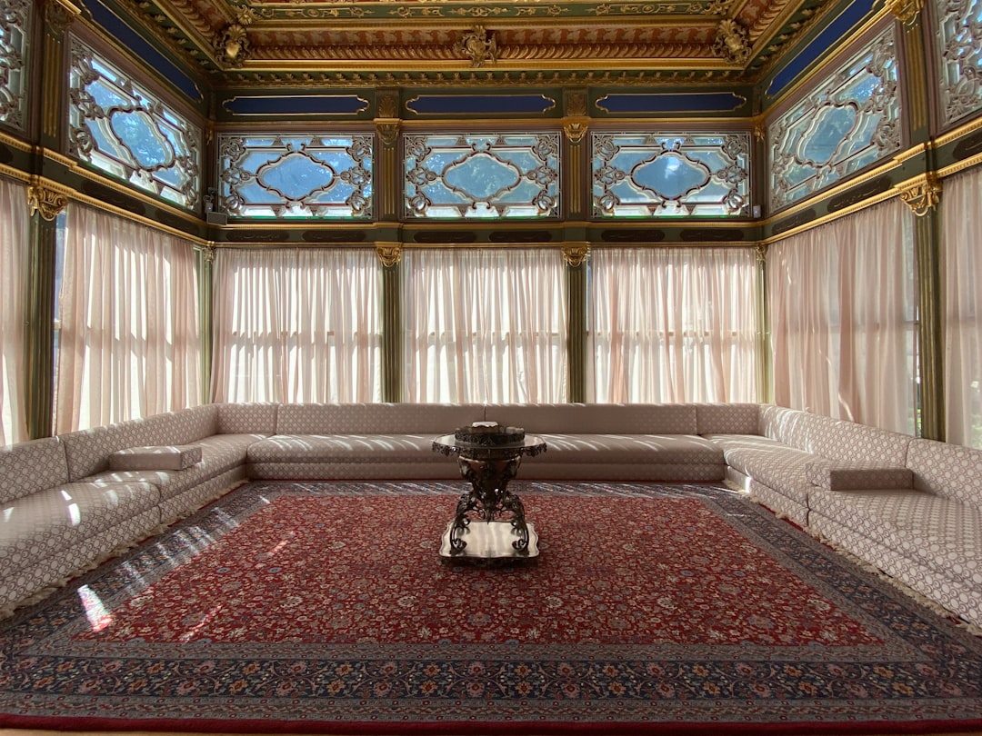 a room with a red carpet and a large chandelier, The sofa Pavilion in the Topkapi Palace in Istanbul