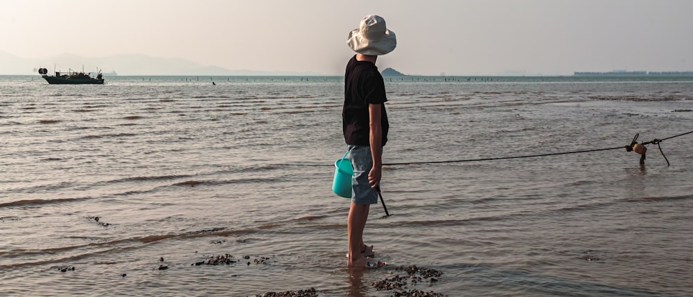 a person holding a fishing pole on a beach