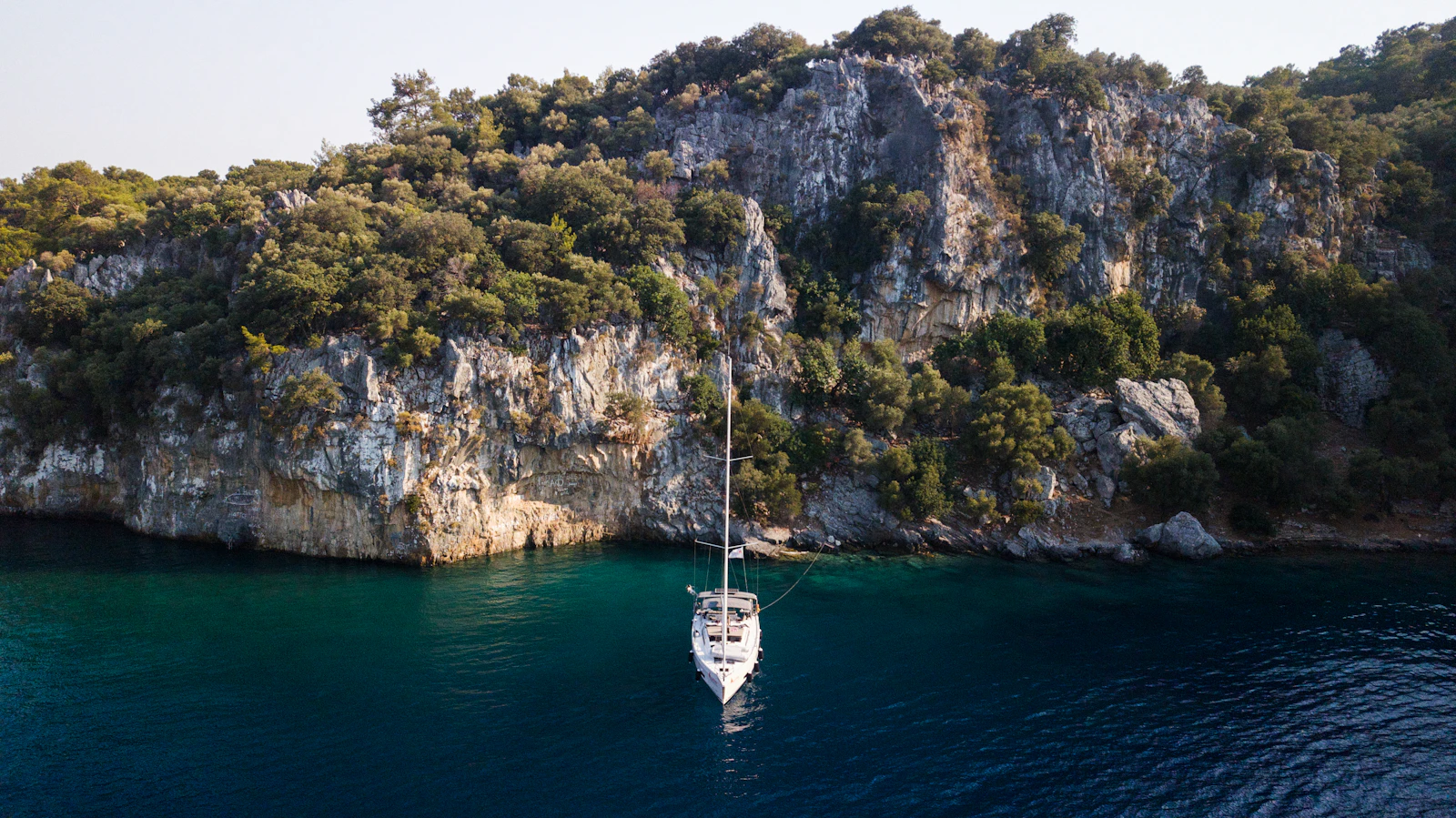Sailing yacht at anchor beneath the cliffs near Göcek