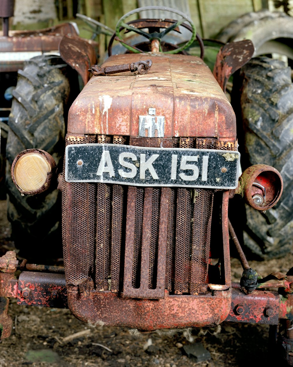a rusted out tractor with a sign on it