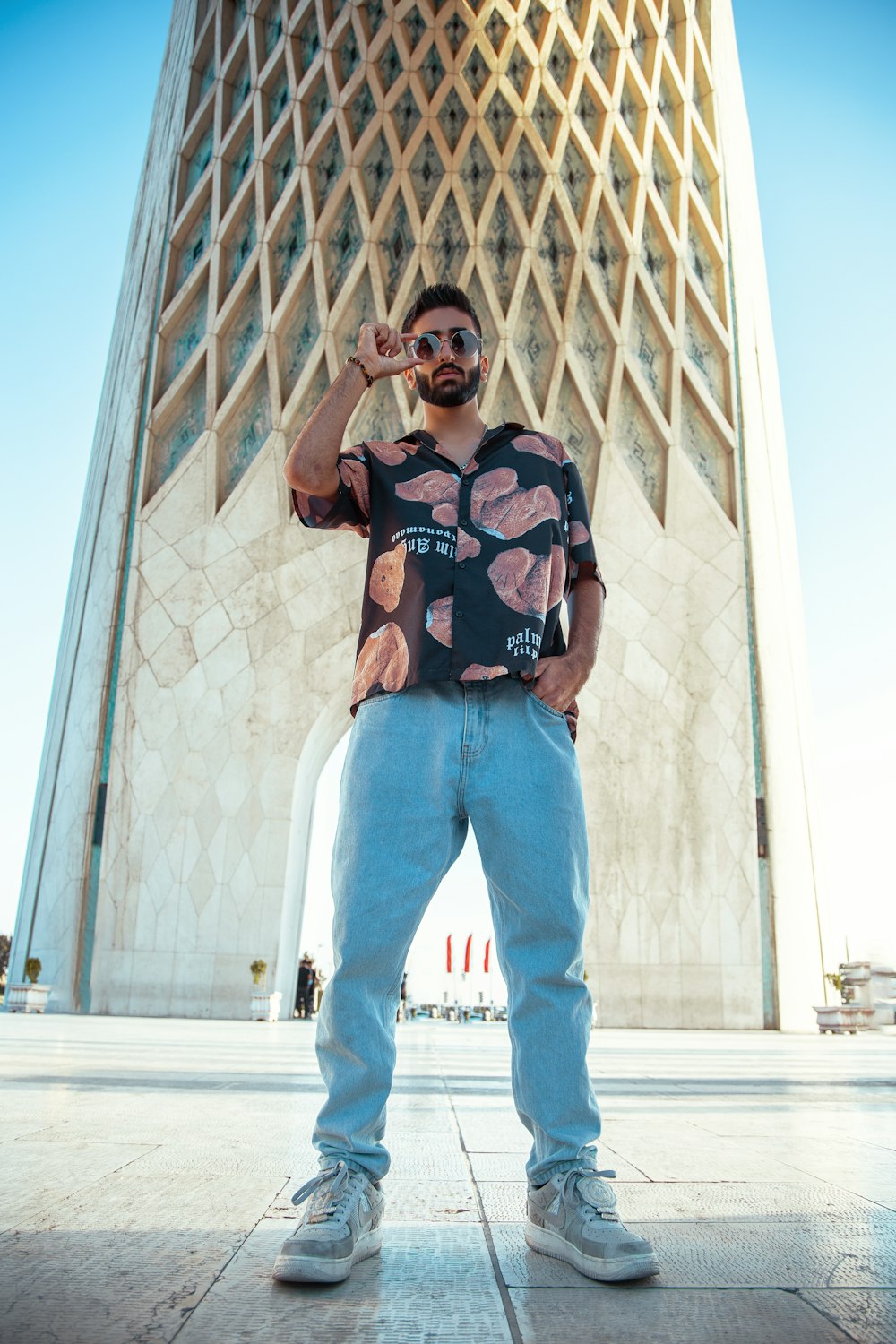 a person posing in front of a building