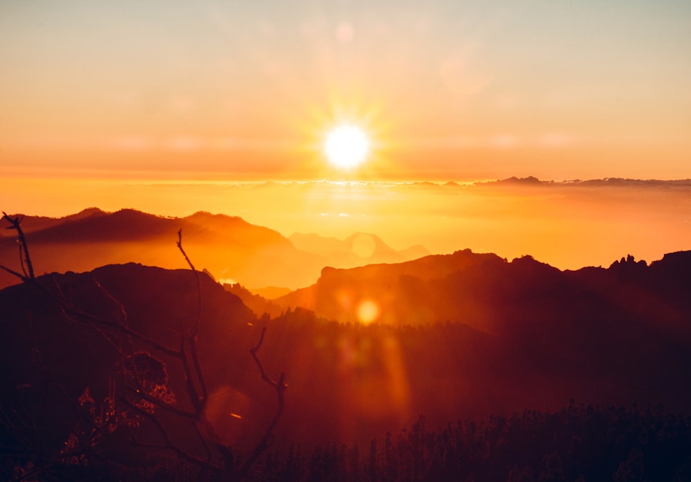 a sunset over a mountain range