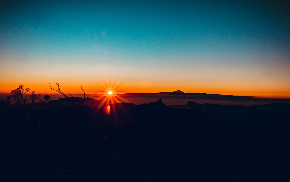 a sunset over a field