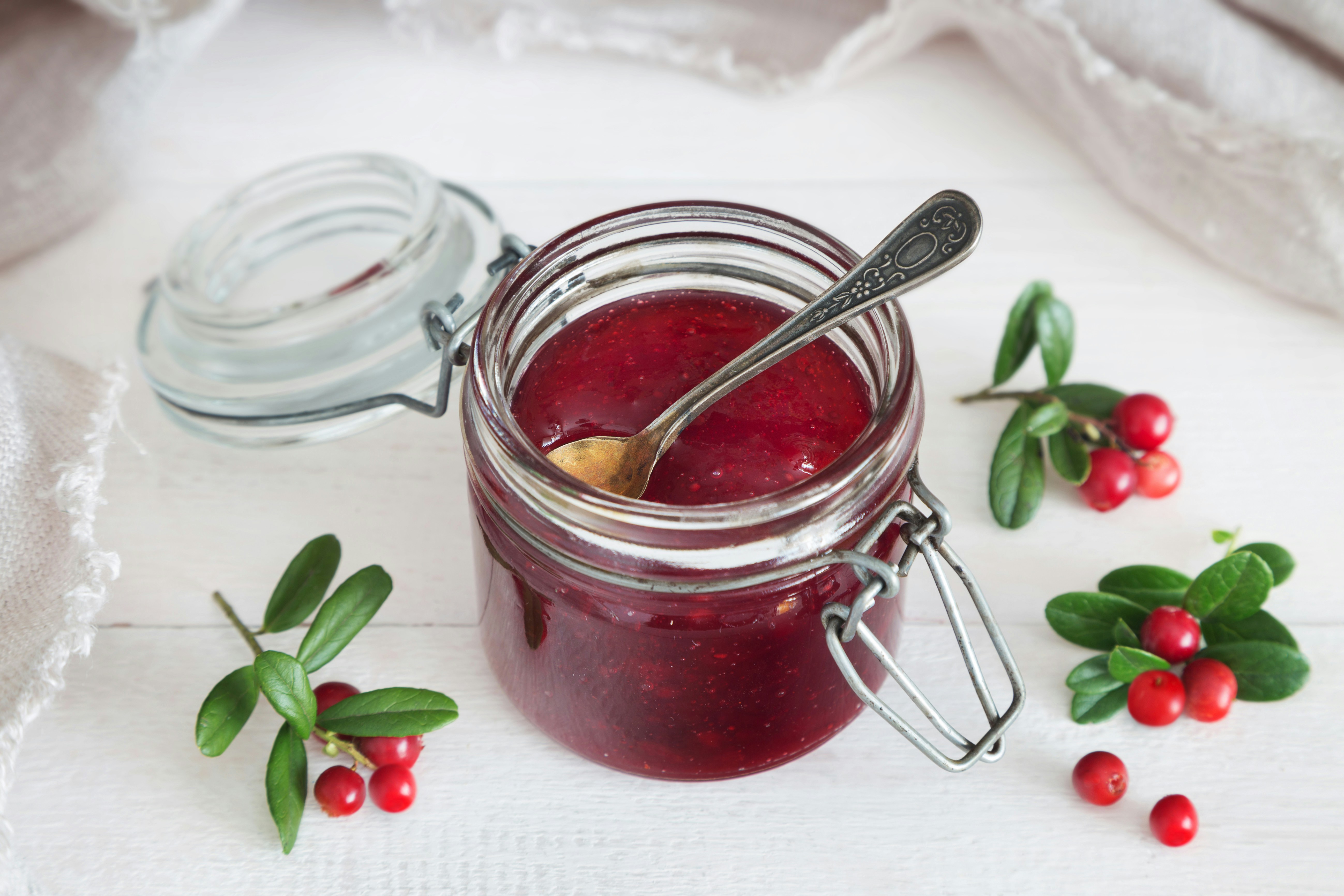 Jar of cranberry jam with a spoon