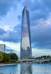 a tall building by a river with Bennington Battle Monument in the background