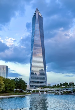 a tall building by a river with Bennington Battle Monument in the background