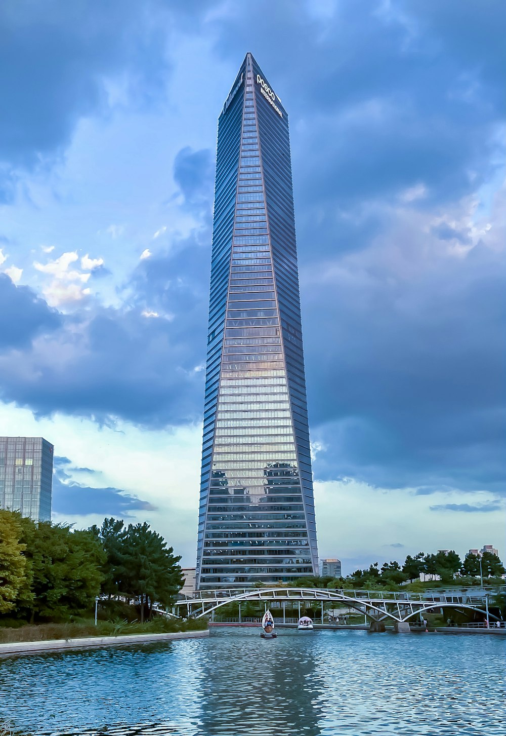 a tall building by a river with Bennington Battle Monument in the background