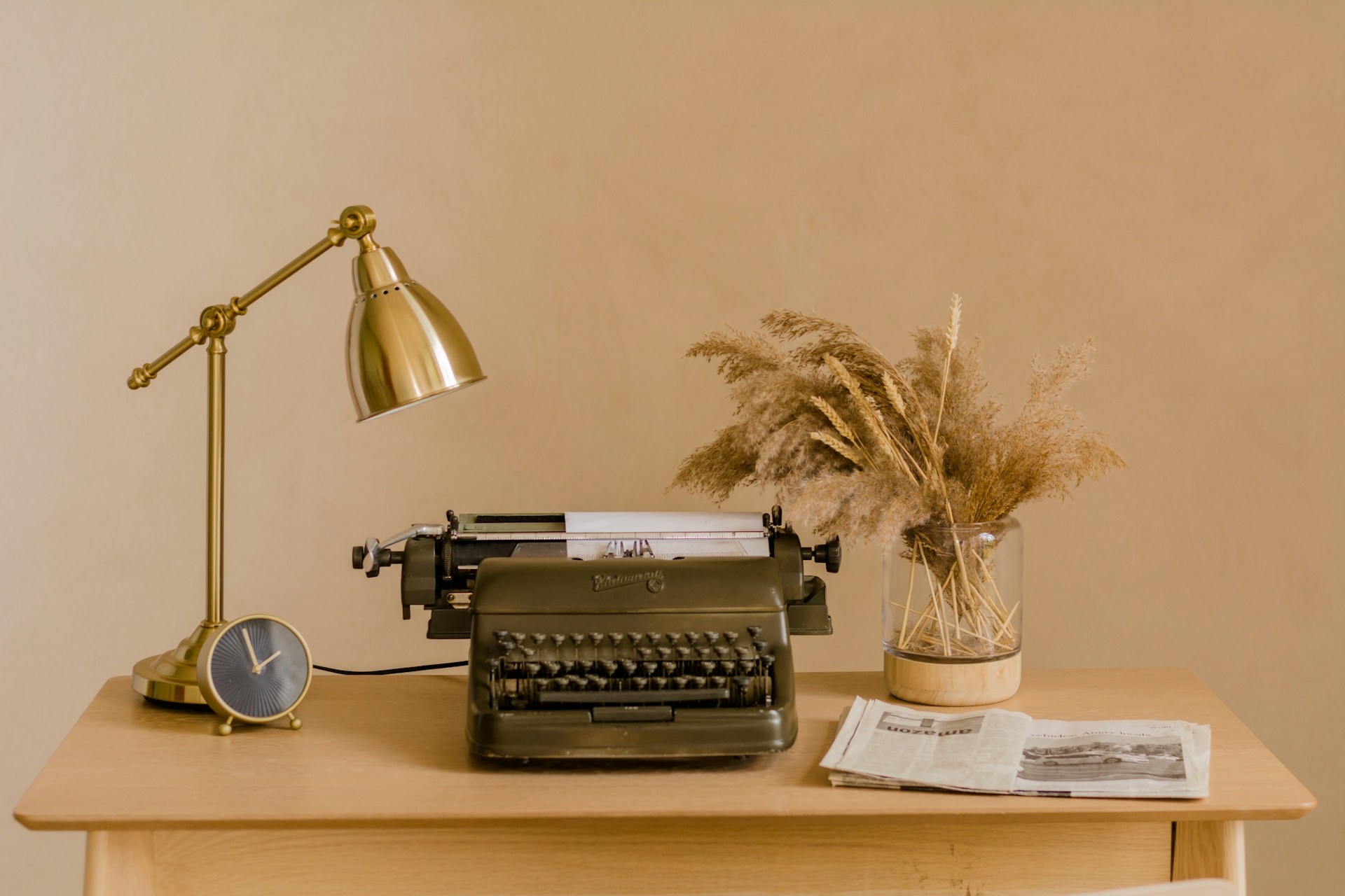 a typewriter and a lamp on a desk