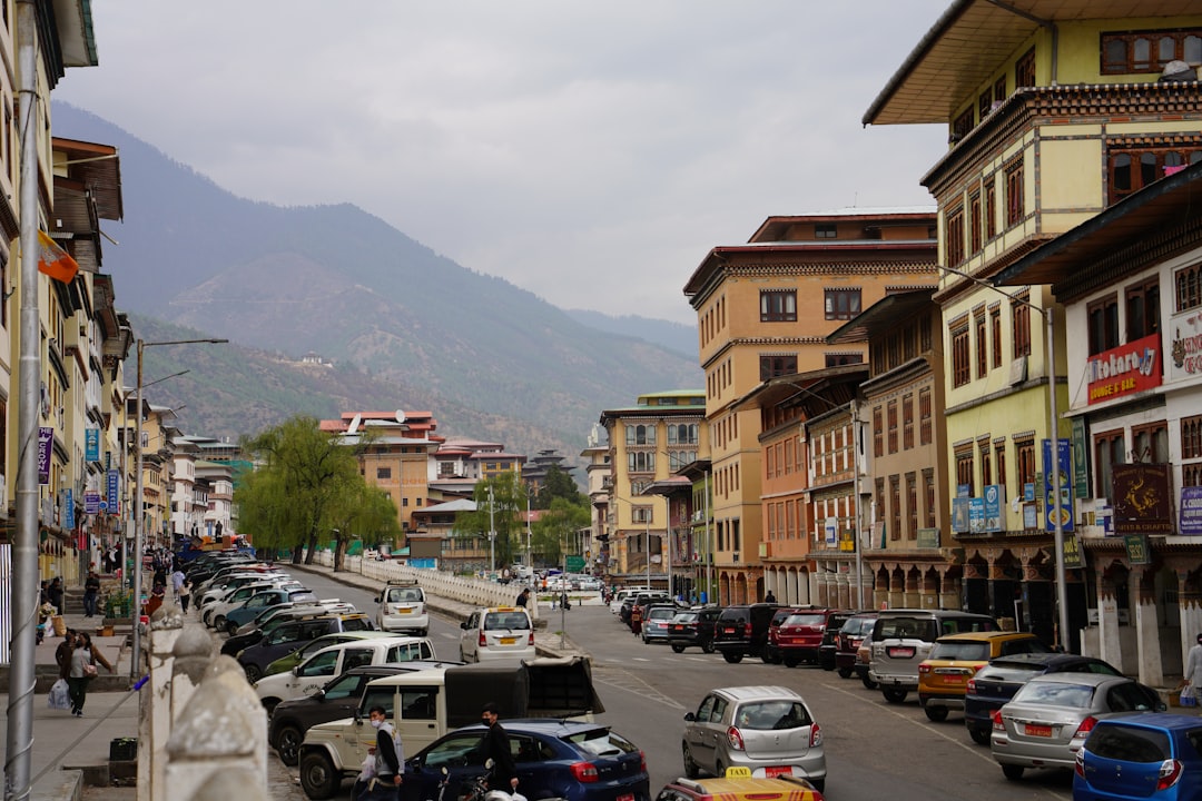 a busy street with cars and buildings, Thimphu city
