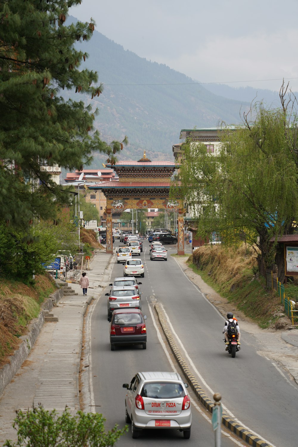 a busy street with cars and motorcycles