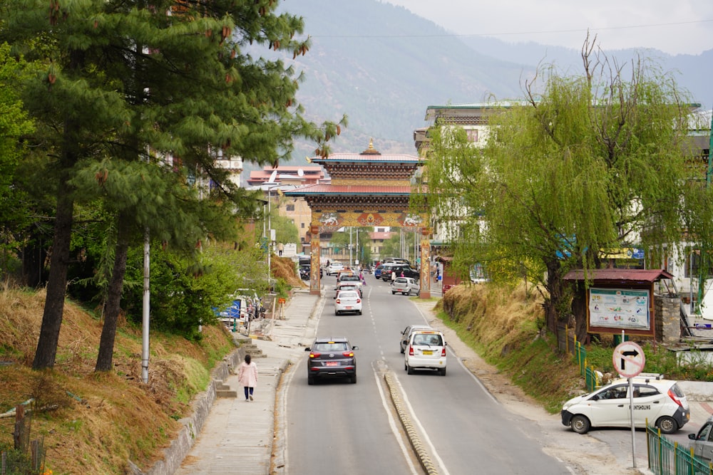 a road with cars on it and buildings on the side