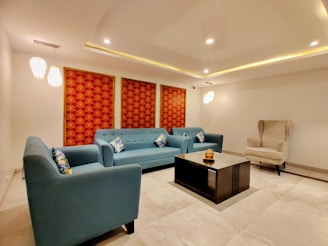 a living room with blue couches