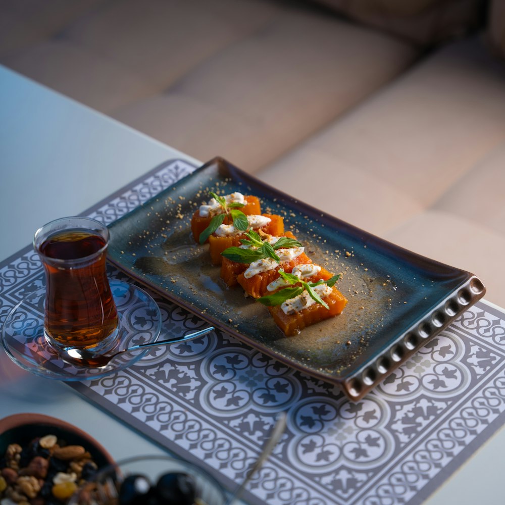 a plate of food and a glass of beer on a table