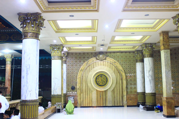 Elegant majlis seating arrangement with plush cushions and intricate woodwork