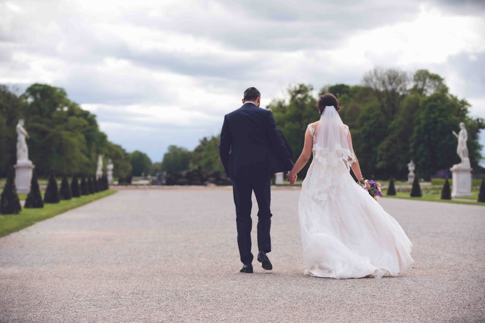 a man and woman walking down a road