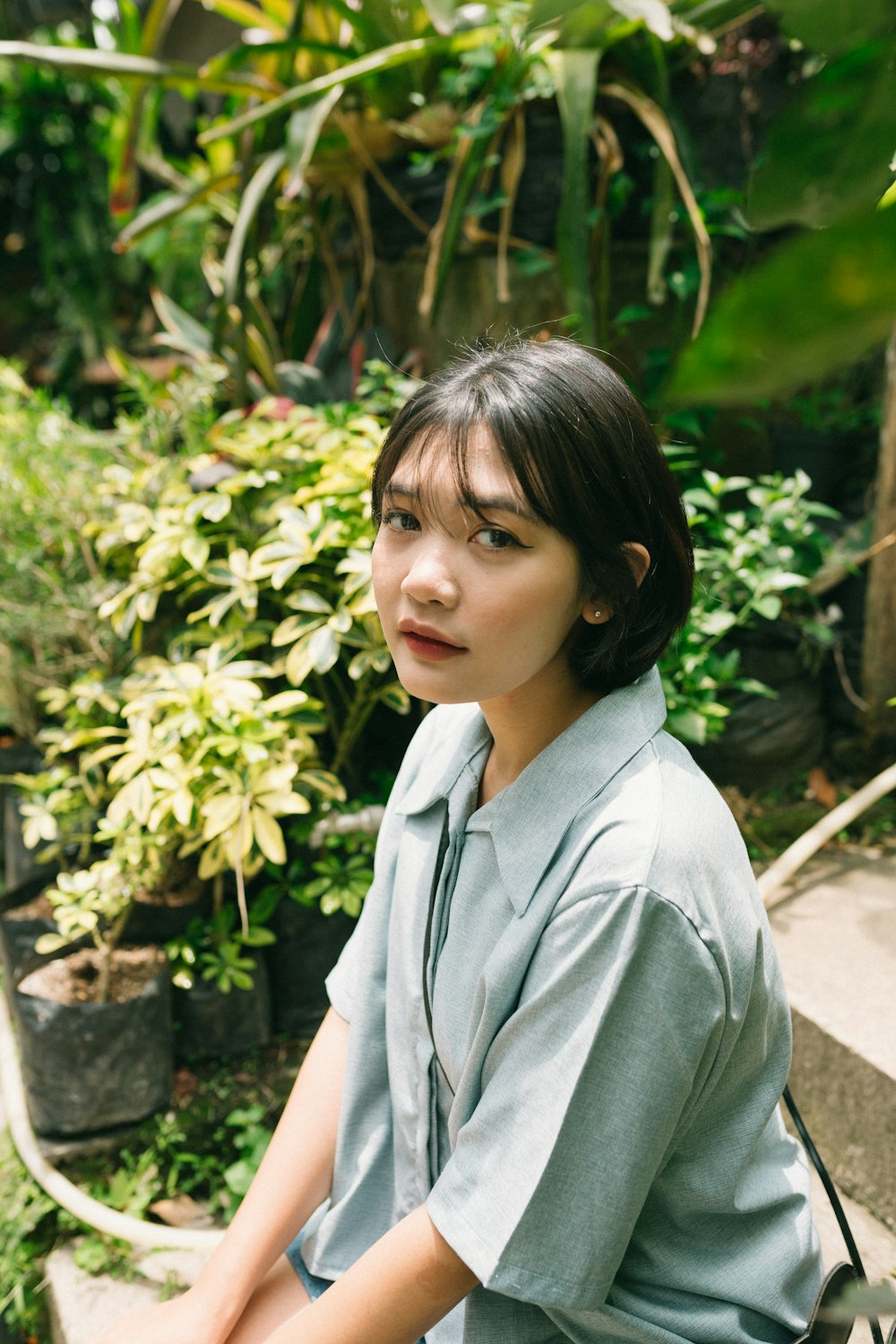 a person standing in front of a plant