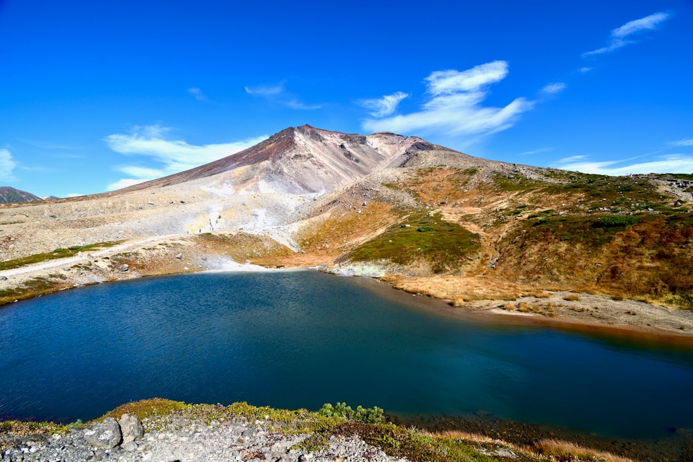 a body of water with a mountain in the background