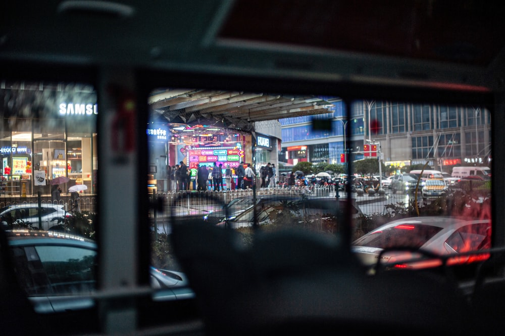 a view of a street through a window of a city street