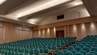 a room with rows of blue chairs