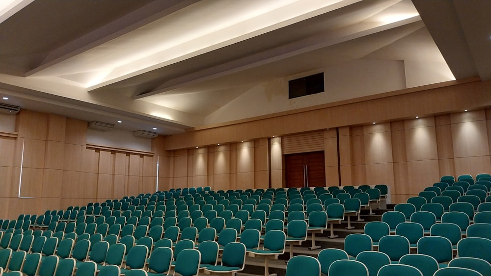 a room with rows of blue chairs