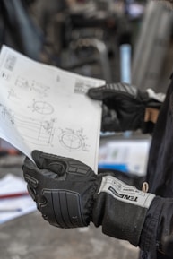 a gloved hand holding a sign