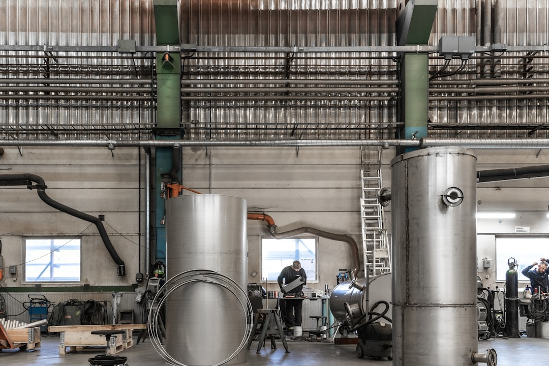 a large factory with several large pipes, A workshop.