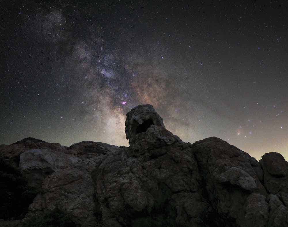 a rocky mountain with stars in the sky