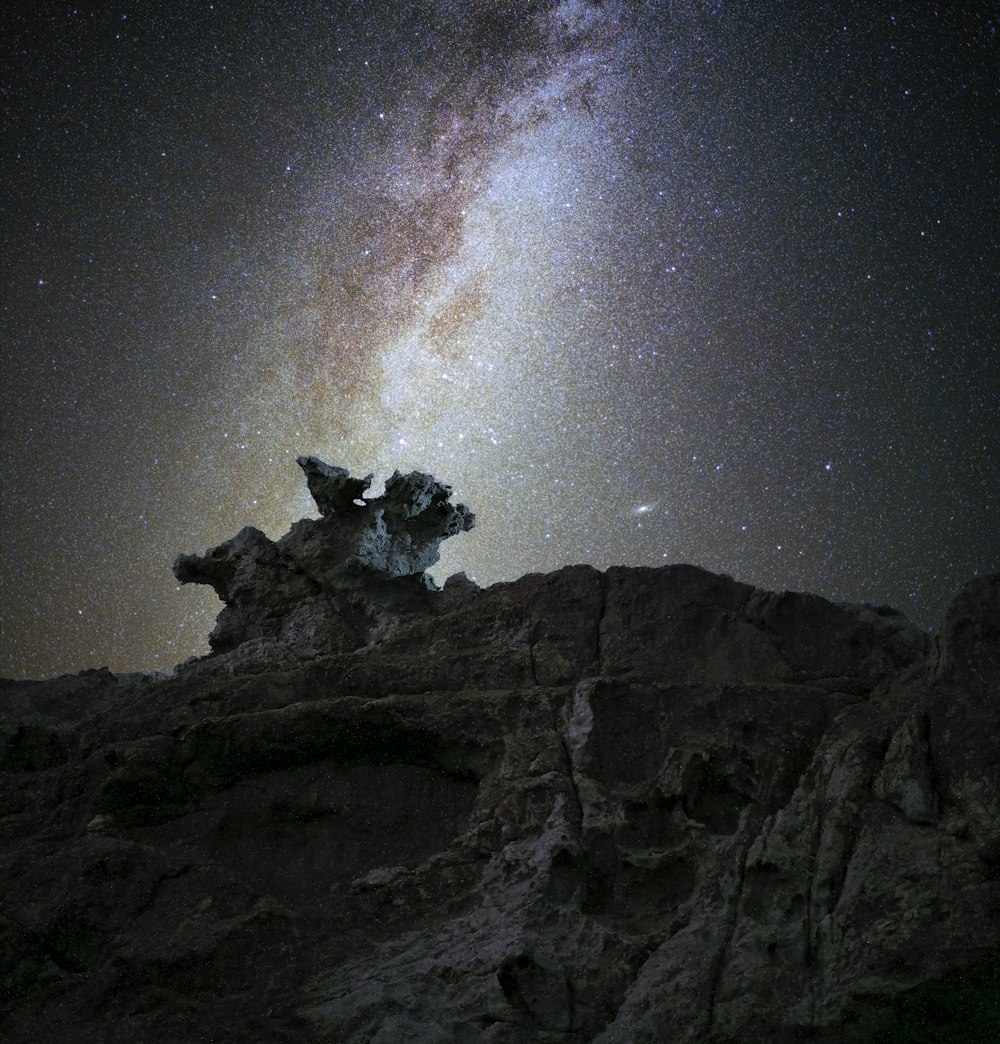 a rocky mountain with a star in the sky