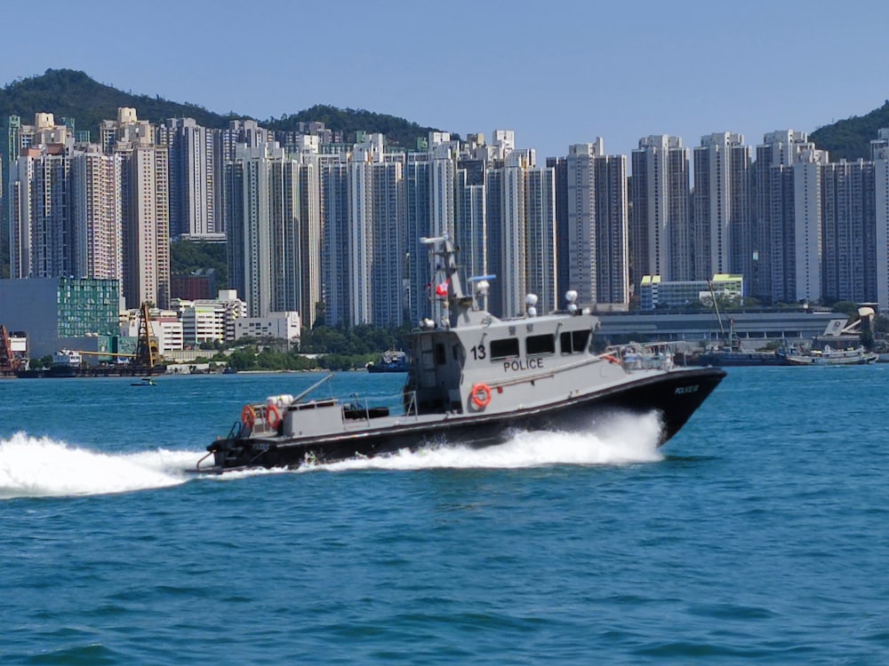 a boat in the water with a city in the background