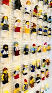 A collection of classic Lego sets displayed on a shelf.