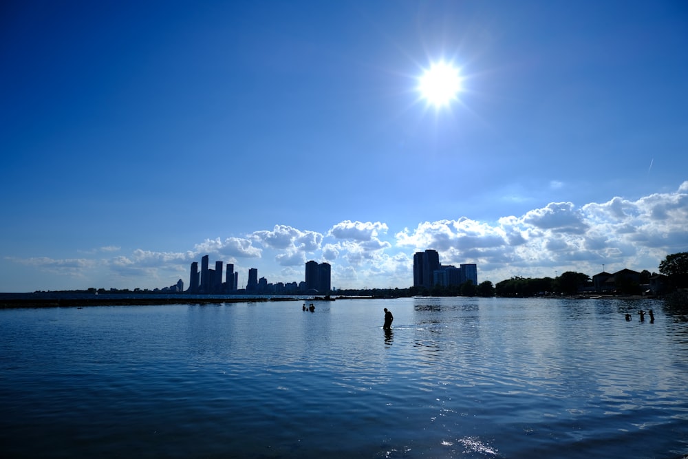 a body of water with a city in the background