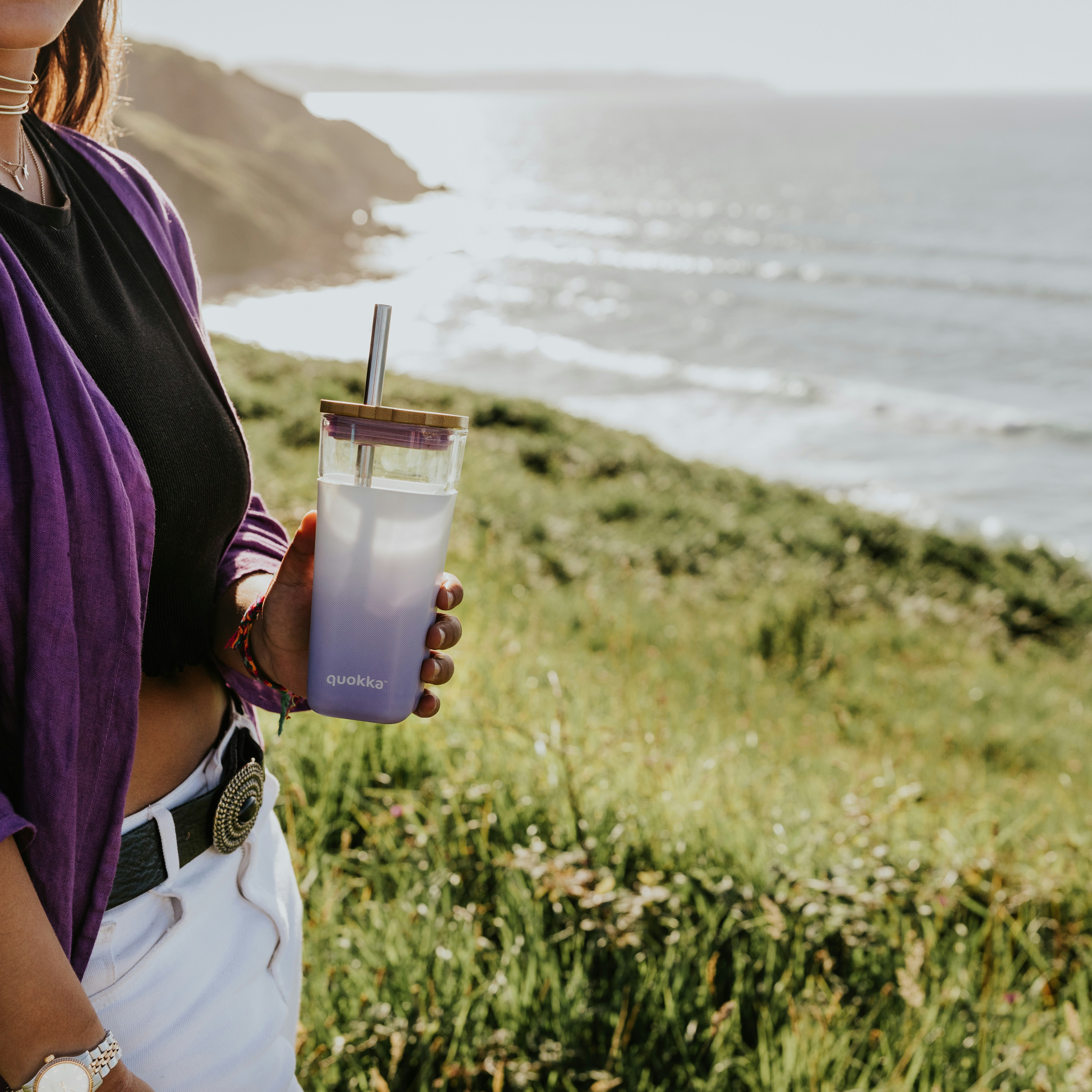 a woman holding a drink