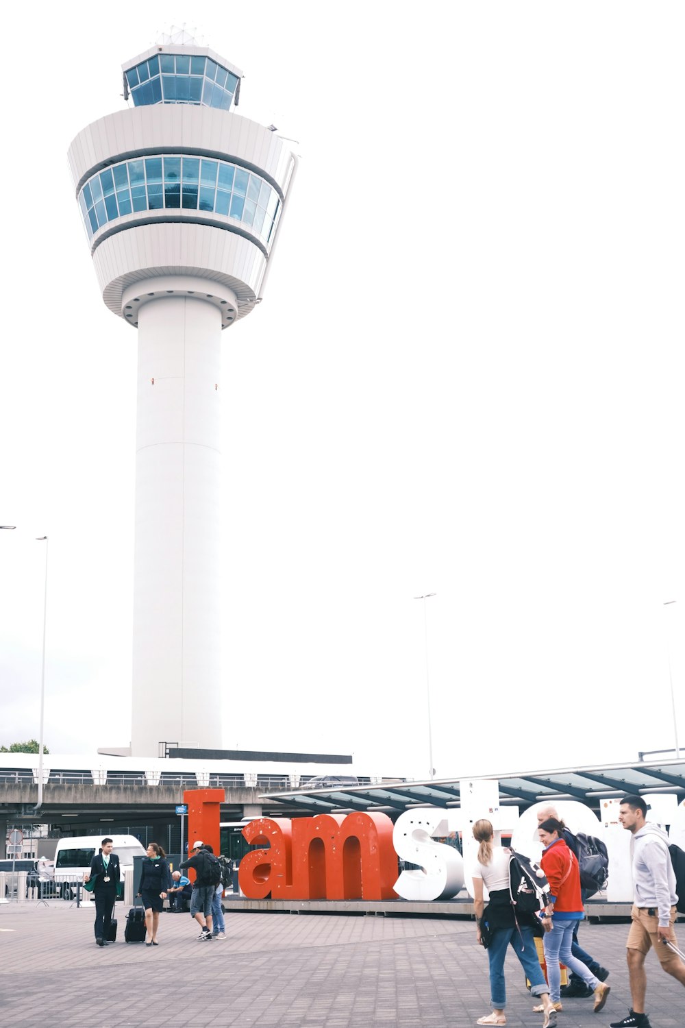 a group of people walking around a tower