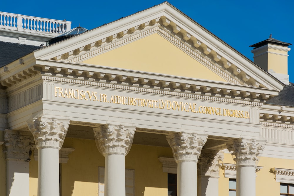 a building with columns and a sign