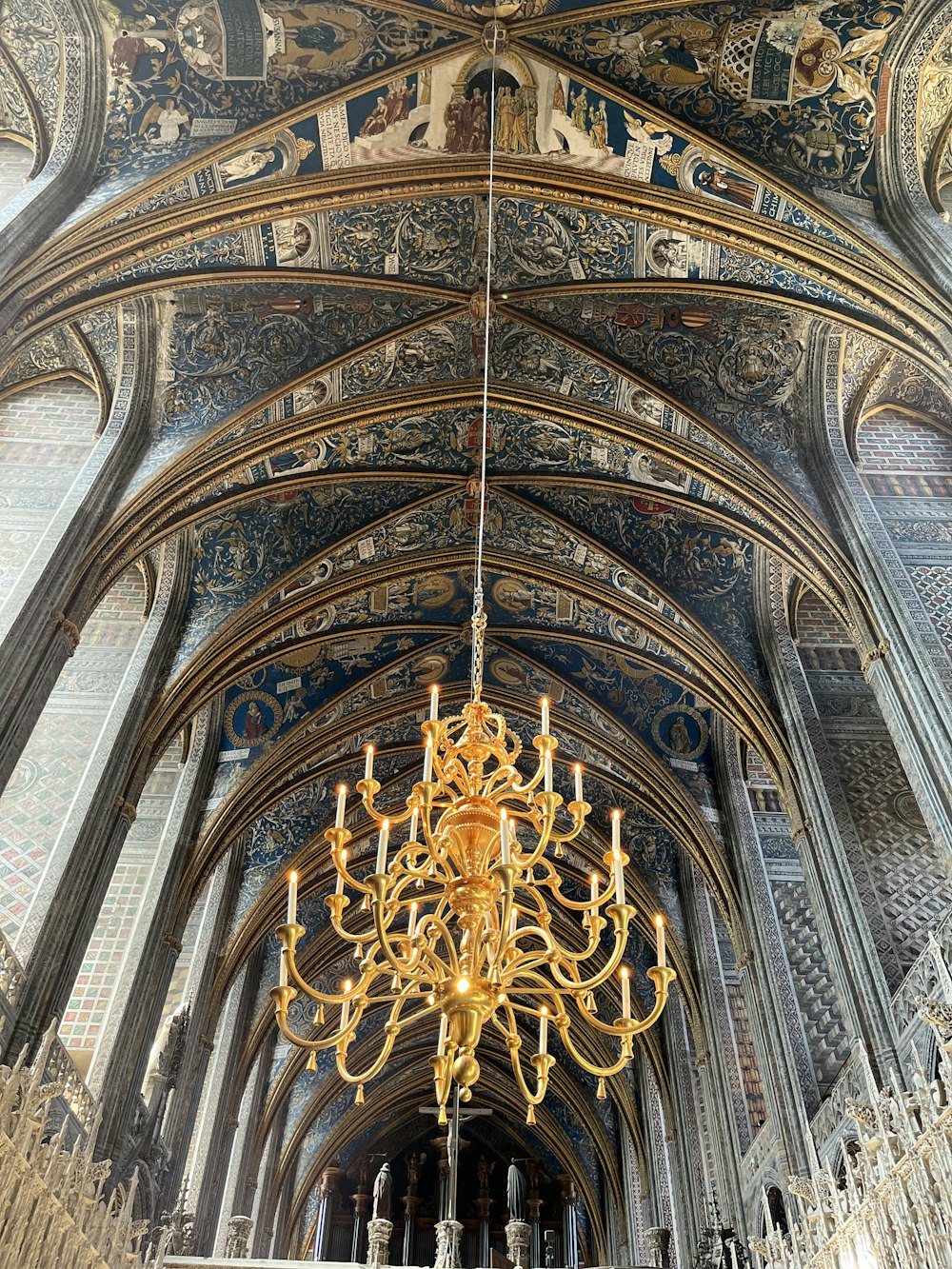 a large ornate ceiling with a gold statue