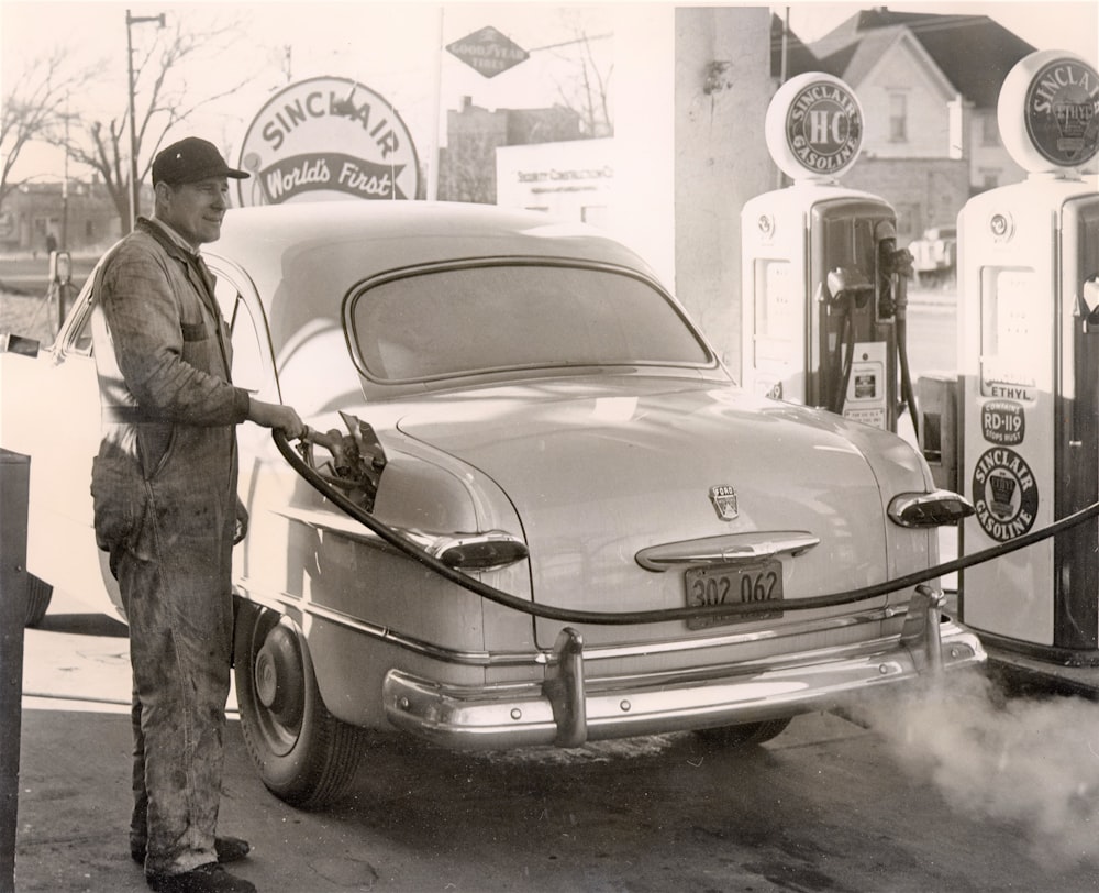 a man standing next to a car