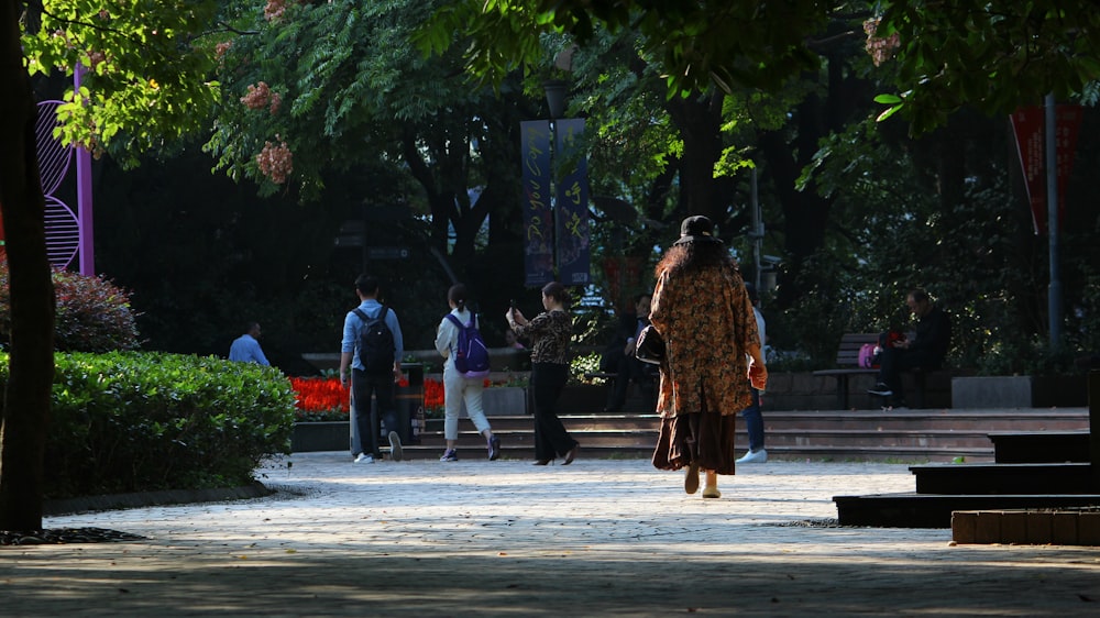 a group of people walking on a sidewalk