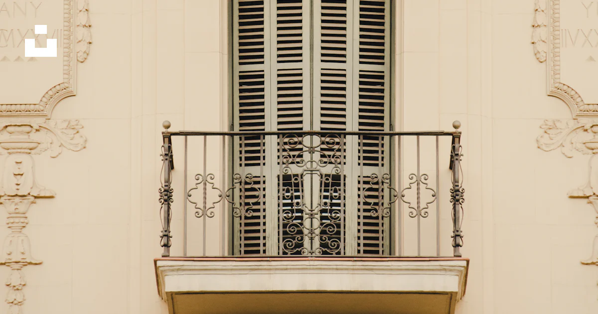 A window with a railing and a balcony with a railing photo – Free ...
