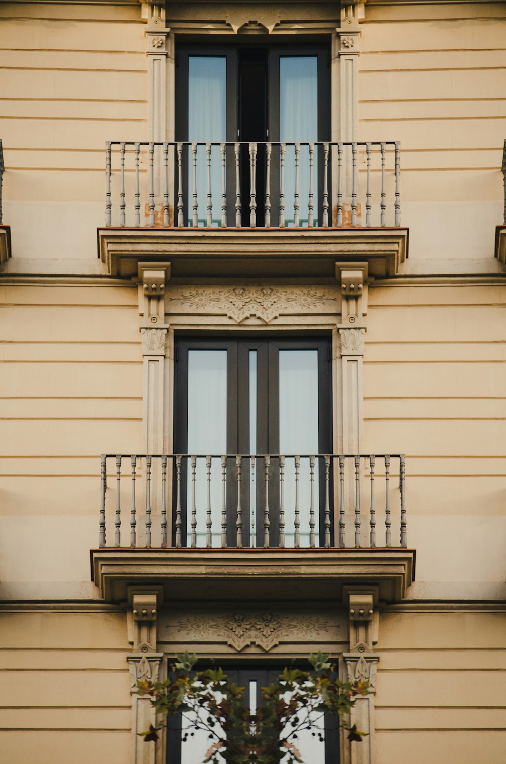 a balcony with a railing and a door with a window