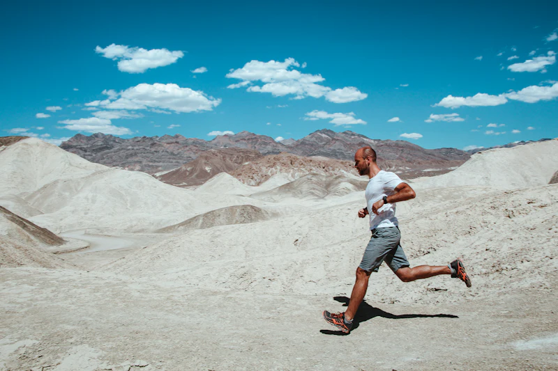 Runner in the arid desert under strong sun, dry heat