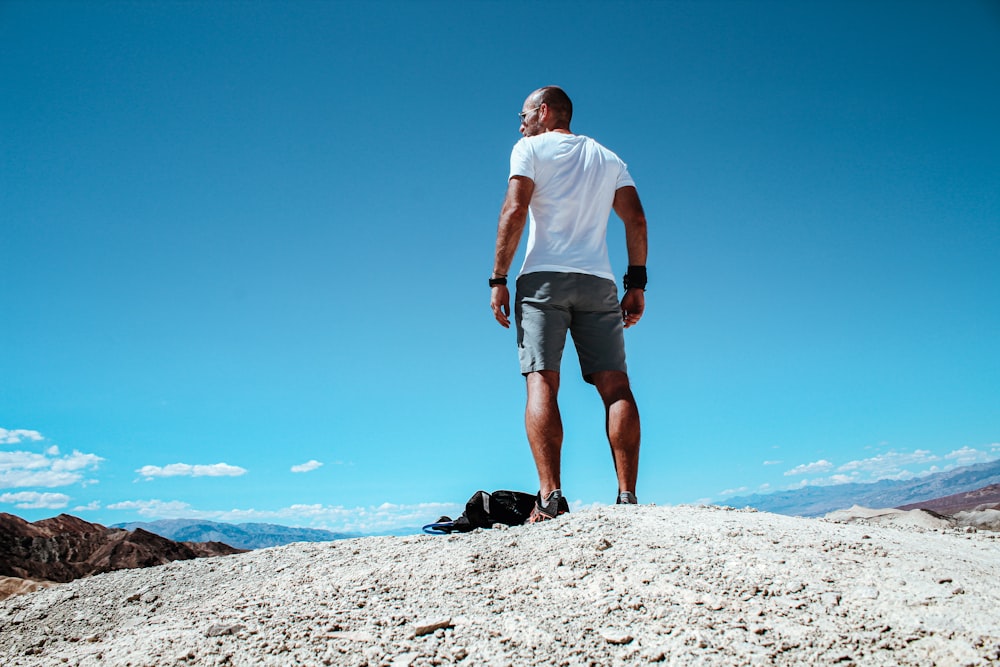 a man standing on a rocky hill