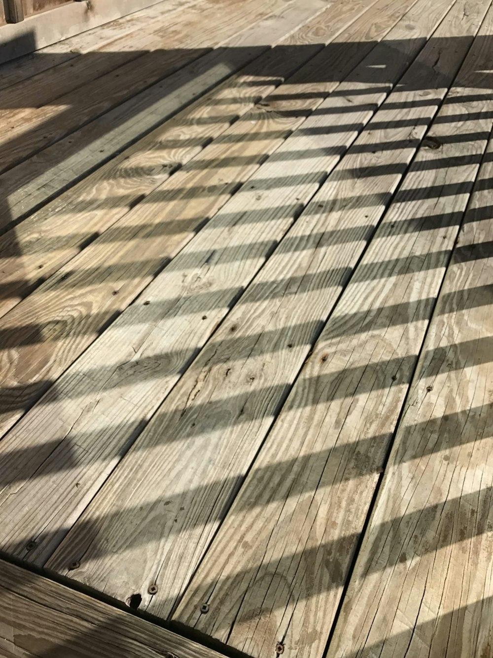 a wooden deck with a shadow